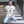 Load image into Gallery viewer, Chichiyasu Milk Coffee graphic tee inspired by the delicious Japanese coffee drink. Cute graphic tee with a black design on a white short-sleeve t-shirt. Cute Japanese graphic tee with Japanese characters and an illustrated design of Chichiyasu Milk Coffee. A cute simple shirt for men or women. Modeled on a cute asian girl hanging out in the street.