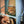 Load image into Gallery viewer, A photo of my adorable cat named Taro. He wears a sweater and is under a chair looking out at the world.