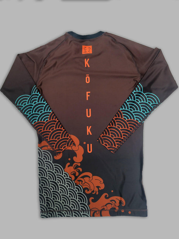 A cool bjj rash guard that features Asian aesthetic graphics. The dark red jiu jitsu rash guard has blue, red, and gray graphic elements and a red logo of Kofuku down the center. This is a rash guard for both men's and women's bjj.