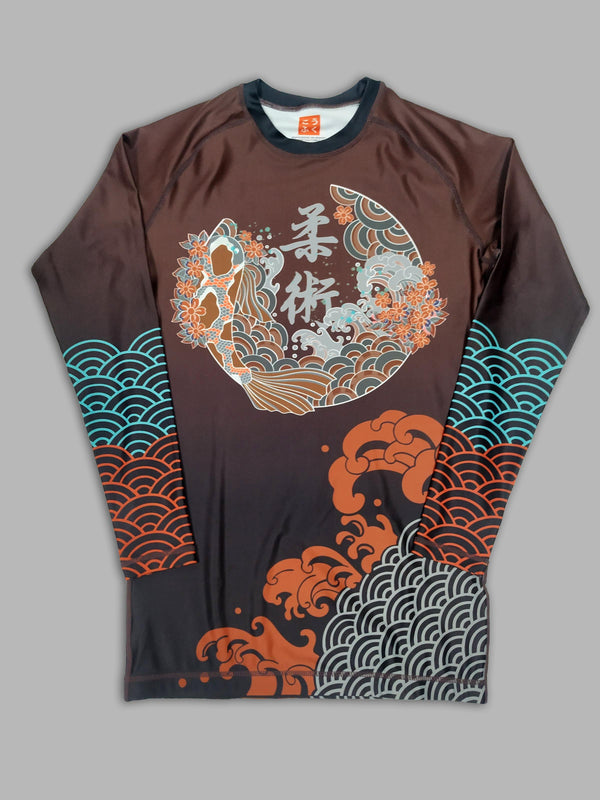 A cool bjj rash guard that features Asian aesthetic graphics. The dark red jiu jitsu rash guard has blue, red, and gray graphic elements and a Koi design in the center. This is a rash guard for both men's and women's bjj.