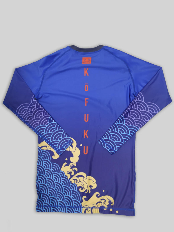 A cool bjj rash guard that features Asian aesthetic graphics. The blue jiu jitsu rash guard has purple, blue, and yellow graphic elements and a red logo of Kofuku down the center. This is a rash guard for both men's and women's bjj.
