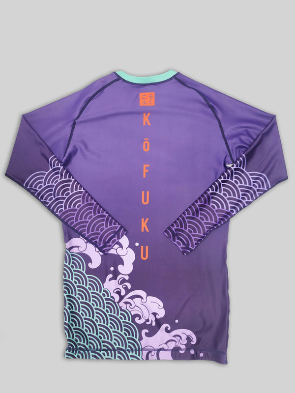 A cool bjj rash guard that features Asian aesthetic graphics. The purple jiu jitsu rash guard has purple and blue graphic elements and a red logo of Kofuku down the center. This is a rash guard for both men's and women's bjj.
