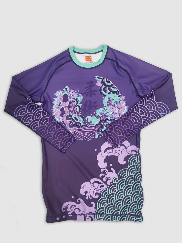A cool bjj rash guard that features Asian aesthetic graphics. The purple jiu jitsu rash guard has purple and blue graphic elements and a Koi design in the center. This is a rash guard for both men's and women's bjj.
