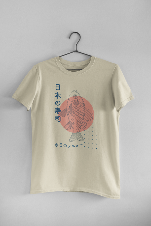 A simple and stylish graphic tee that features a fish and Japanese characters. A cute Japanese shirt that has a unique and stylish graphic design. A navy design with a pink accent on a cream t-shirt.